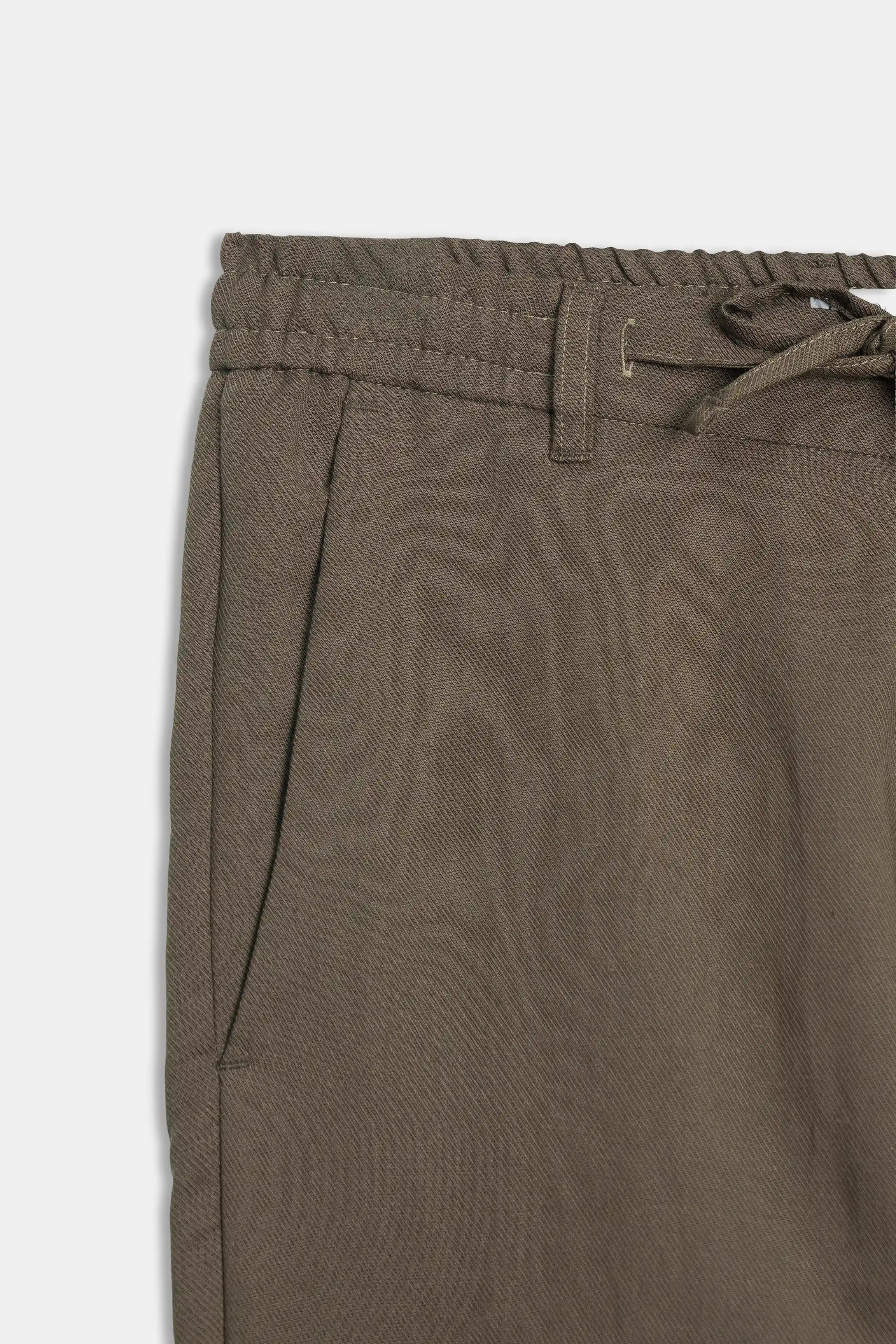 Brown pants waistband with elastic back, drawstring channel, and belt loops
