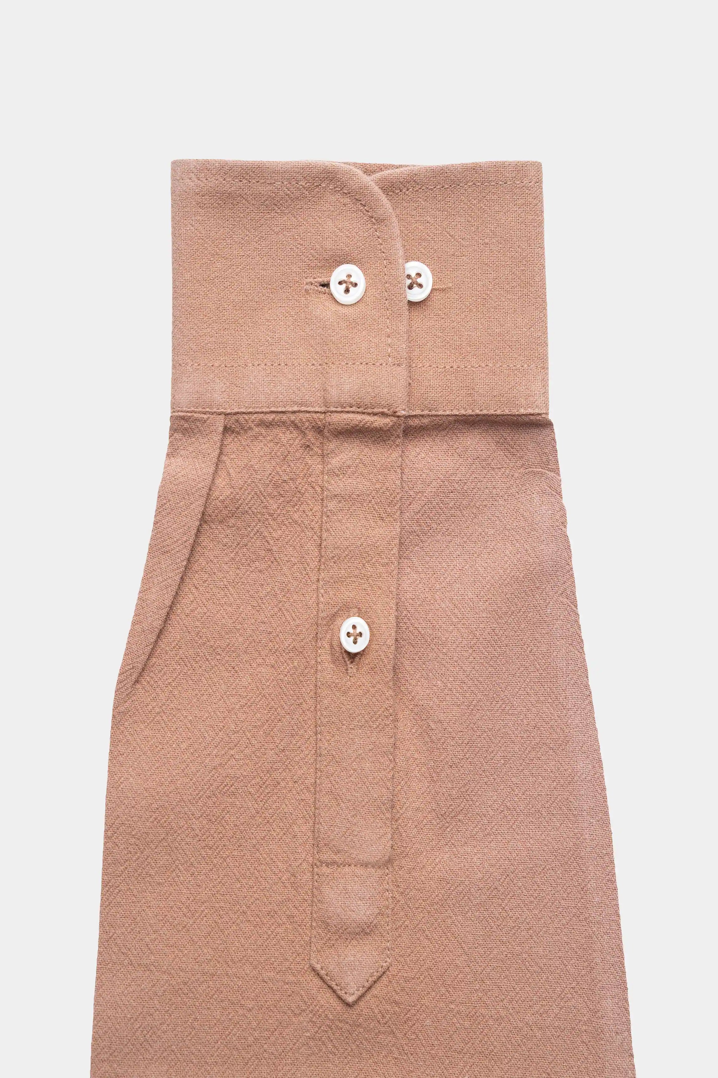 Brown dress shirt button placket detail with two collar buttons and folded collar stand