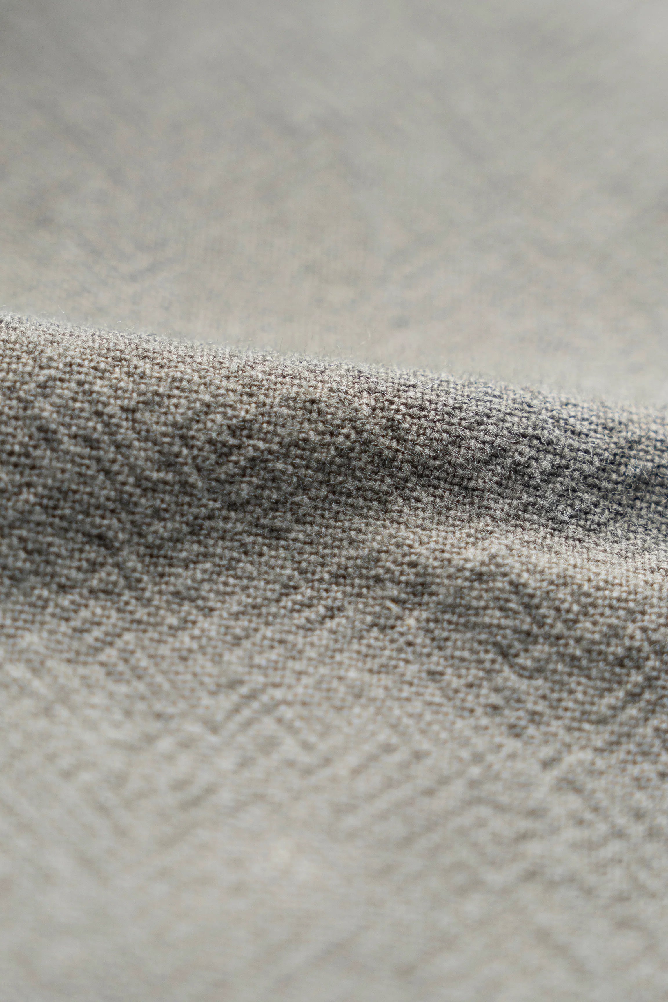 Dark gray woven shirt fabric texture with seam stitching detail