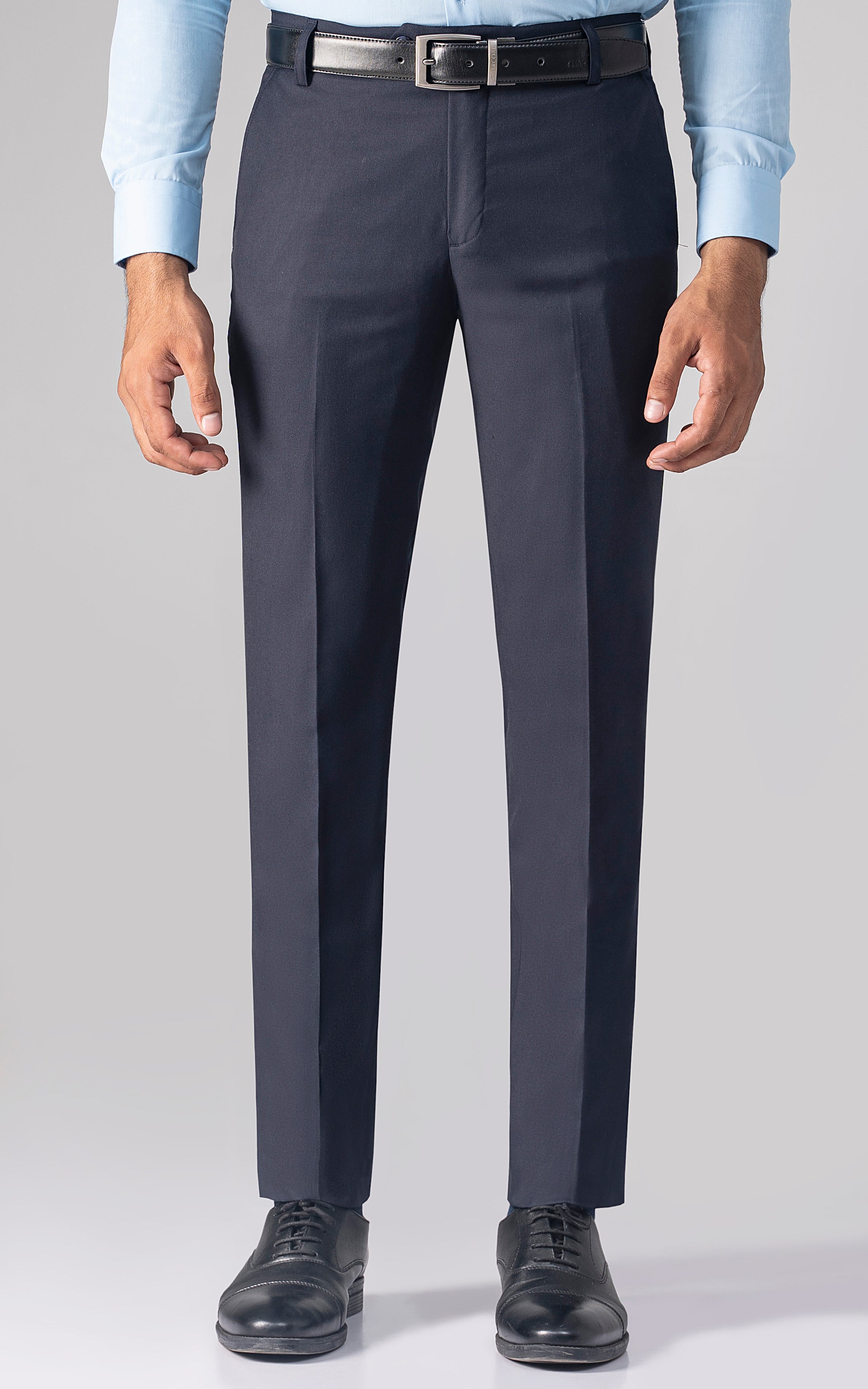 Navy dress pants front view with belt and straight, tapered legs