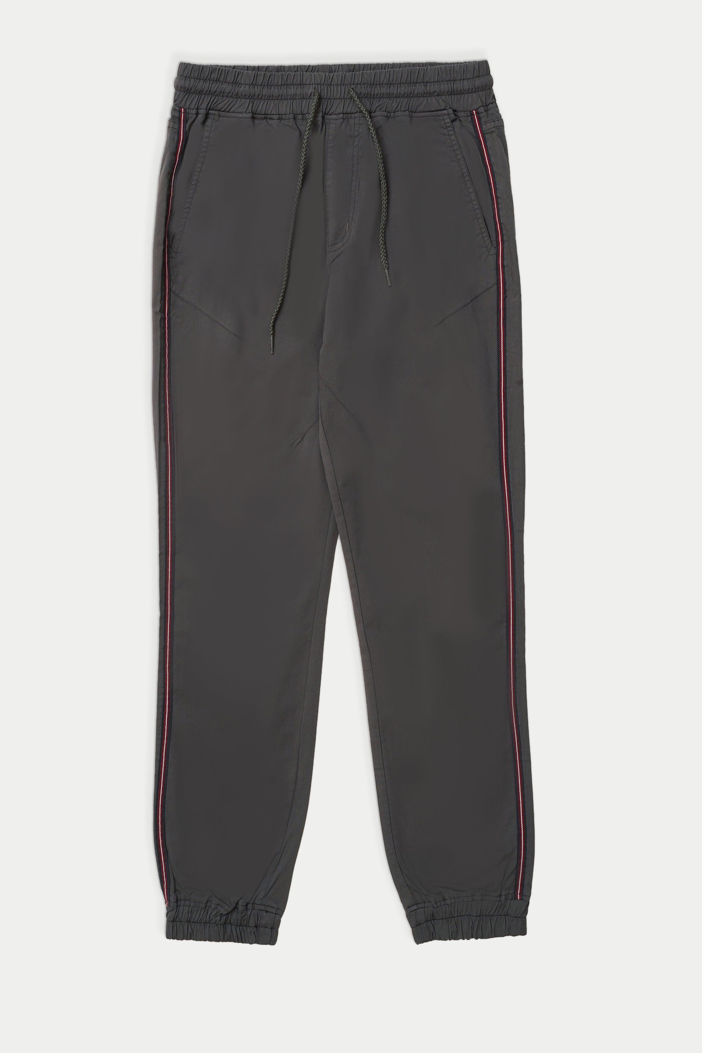 Dark grey casual jogger trousers with elastic cuffs and side stripe