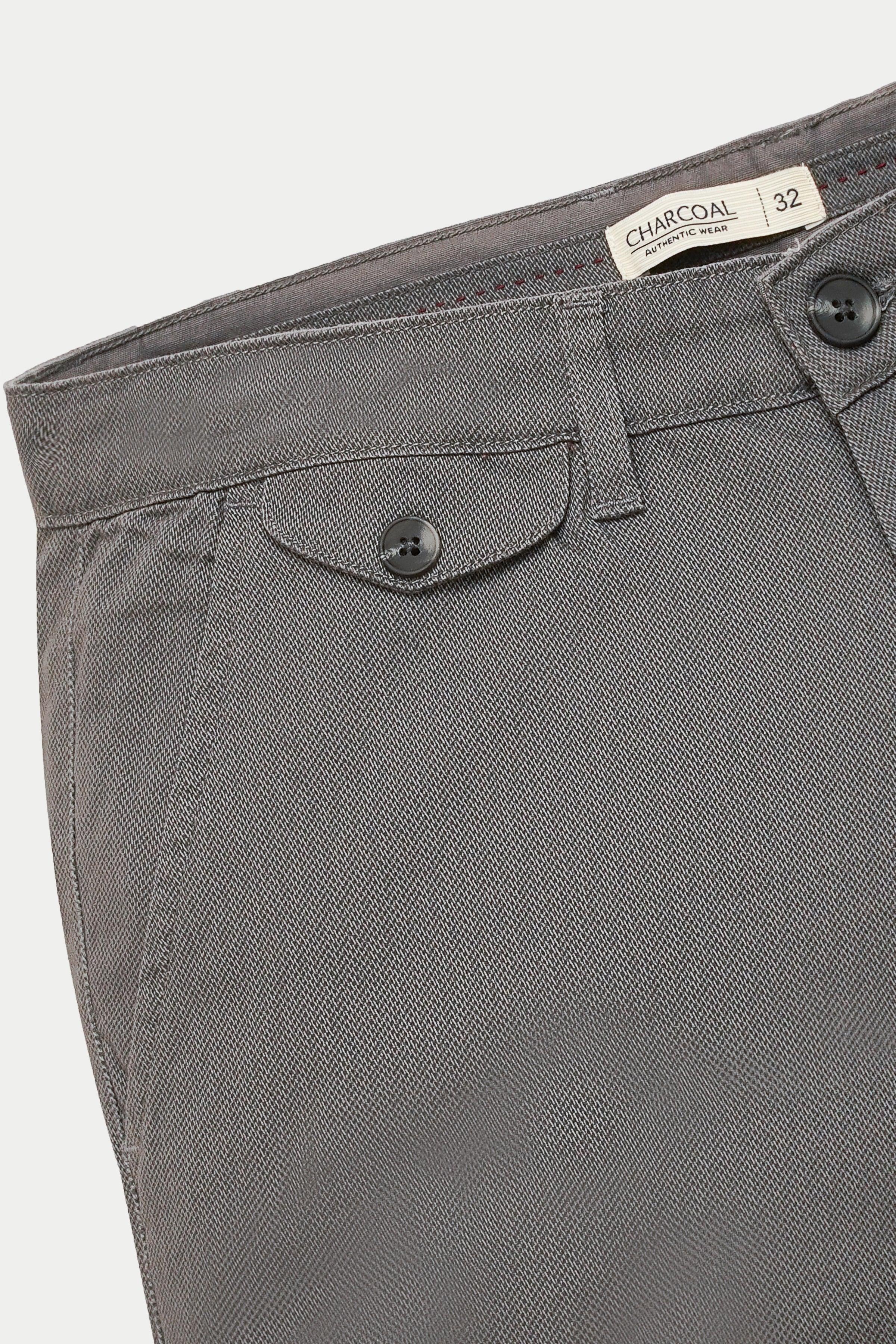 Grey casual pants waistband with button closure, belt loops, and tag