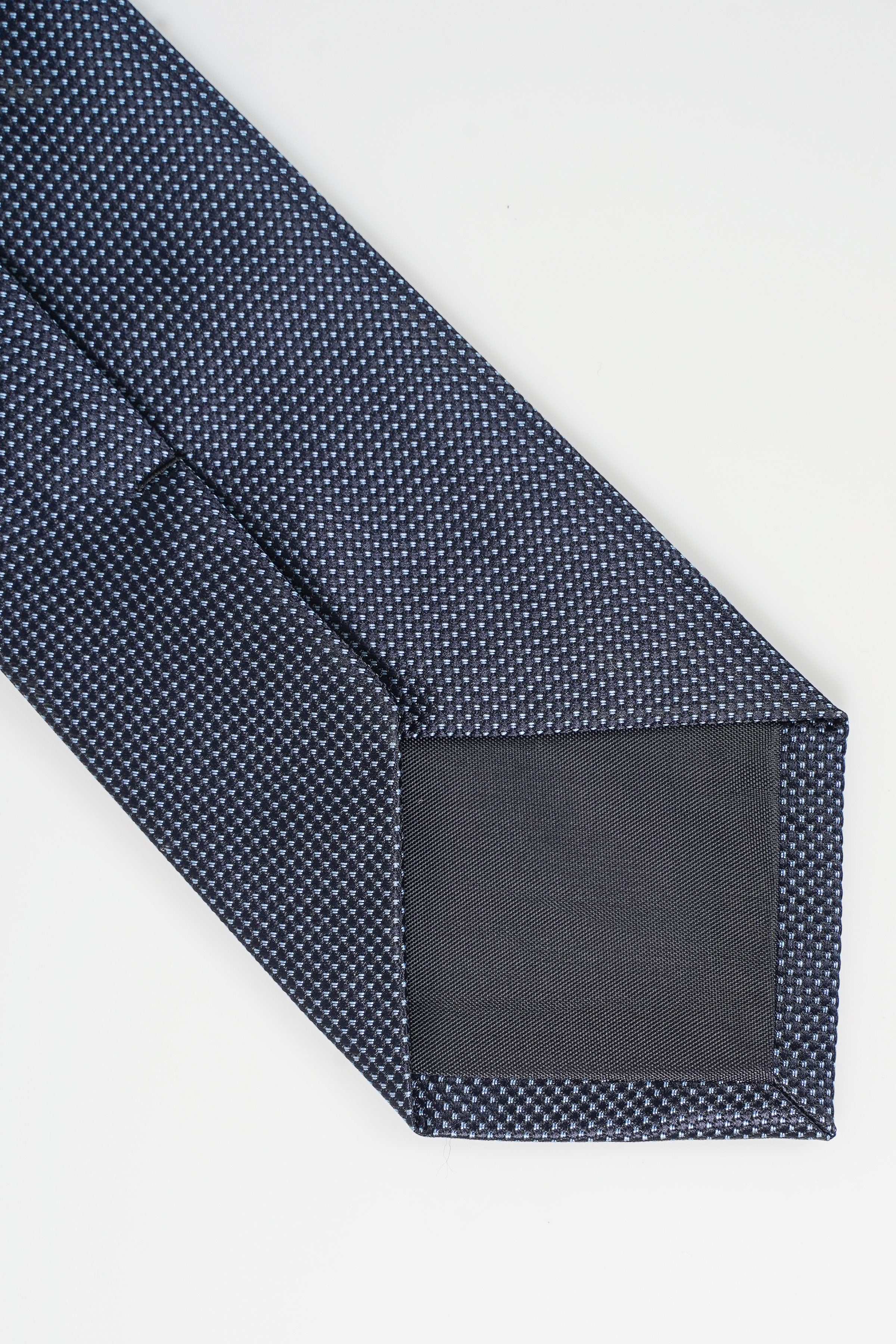 Poly silk tie, dark blue dotted texture, pointed end and seam detail
