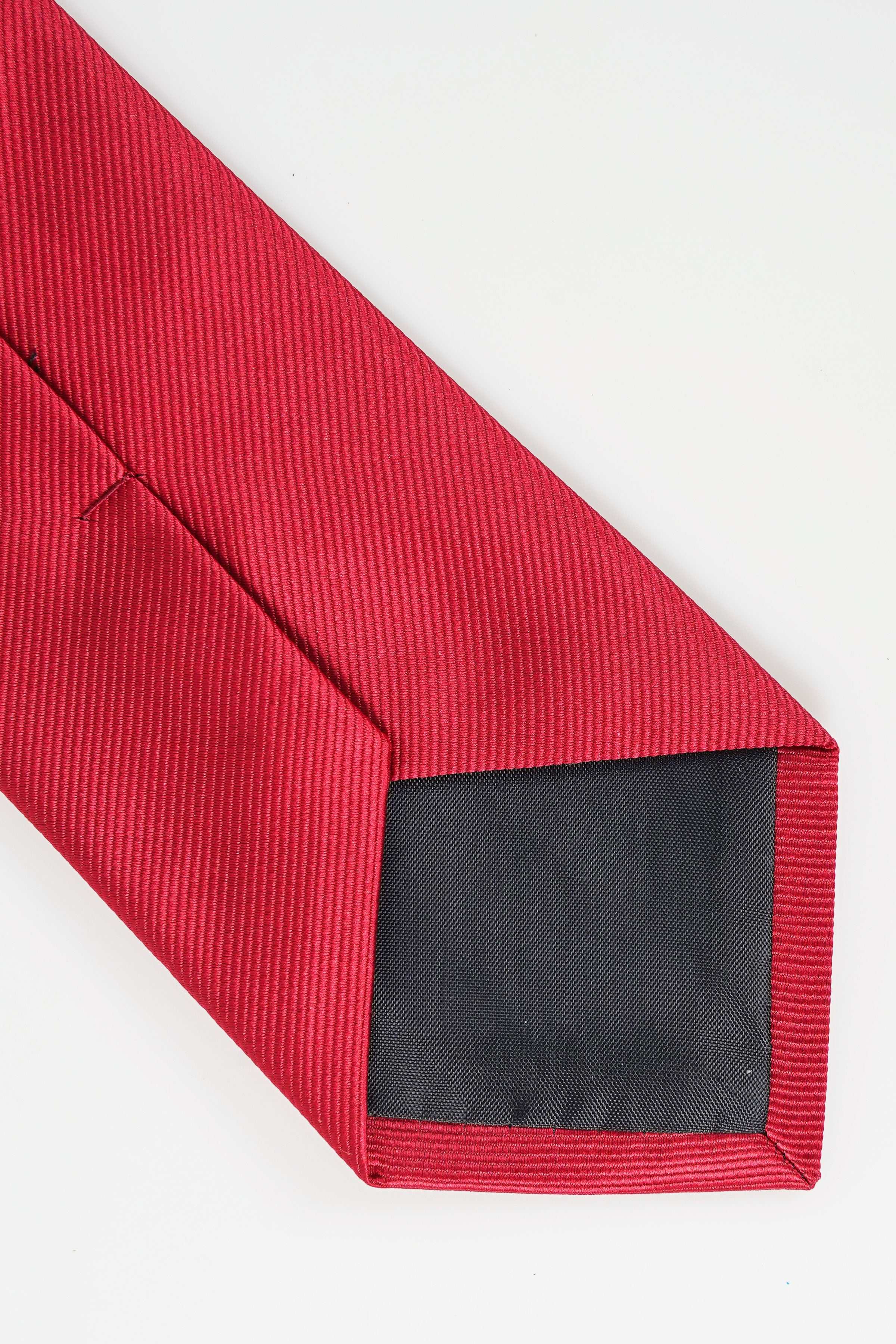 Red poly silk necktie end with visible dark inner lining
