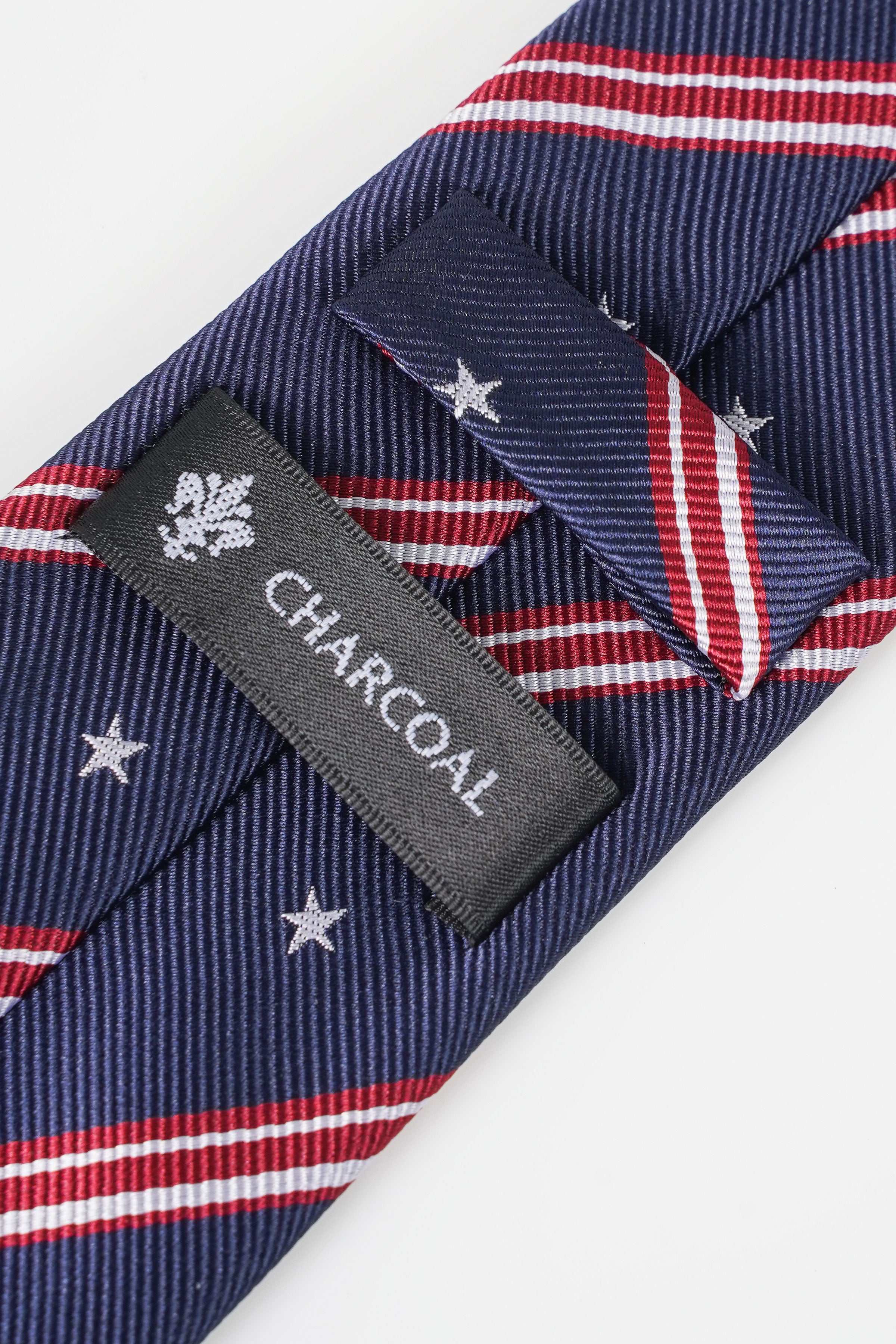 Navy poly silk tie with striped stars and Charcoal label at knot