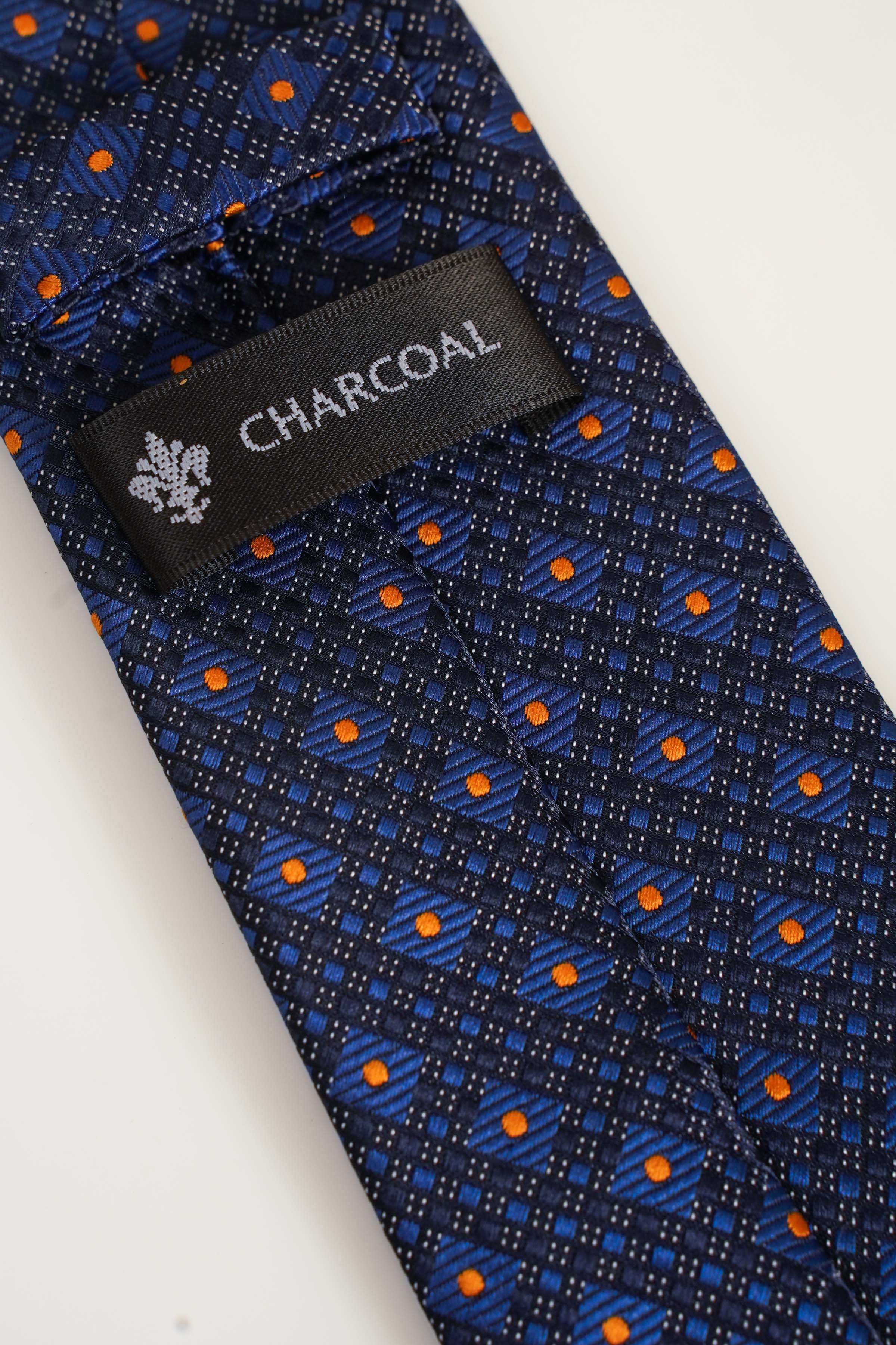 Navy blue poly silk tie with CHARCOAL label and geometric orange pattern