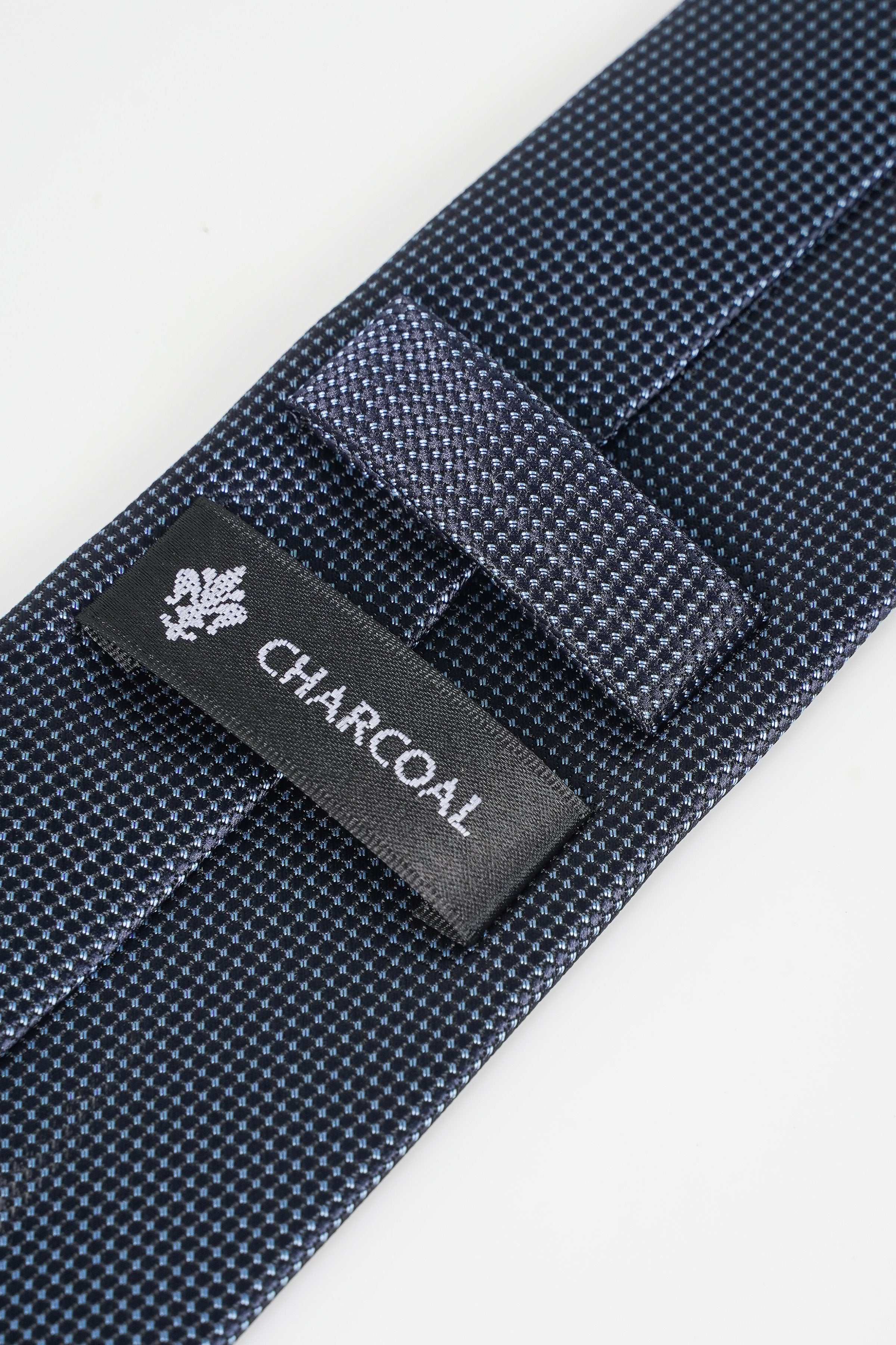 Poly silk tie label CHARCOAL on dark blue dotted fabric