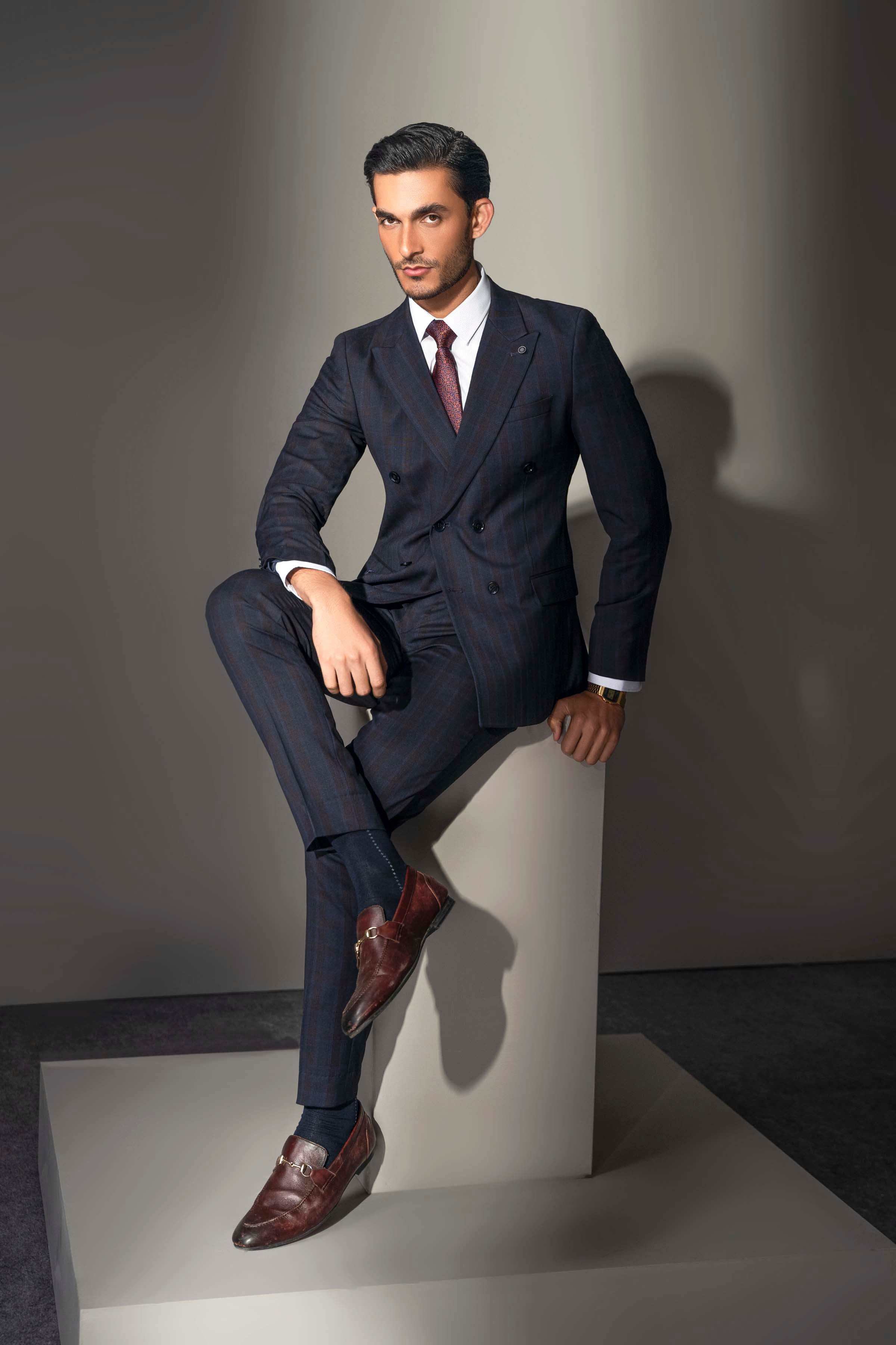 Navy check double-breasted suit worn with white dress shirt and tie