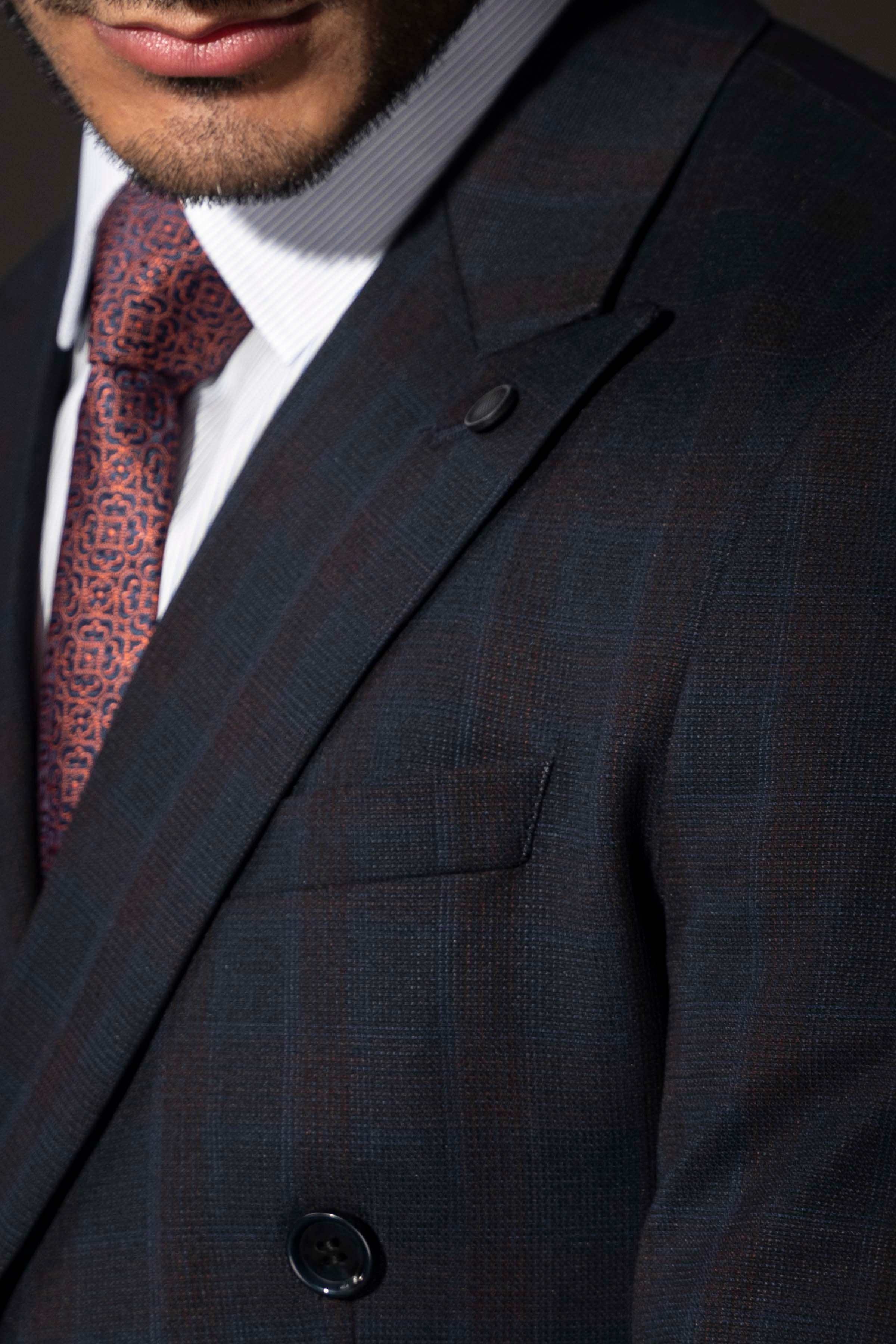 Double-breasted suit jacket lapel, front pocket, and dark button detail