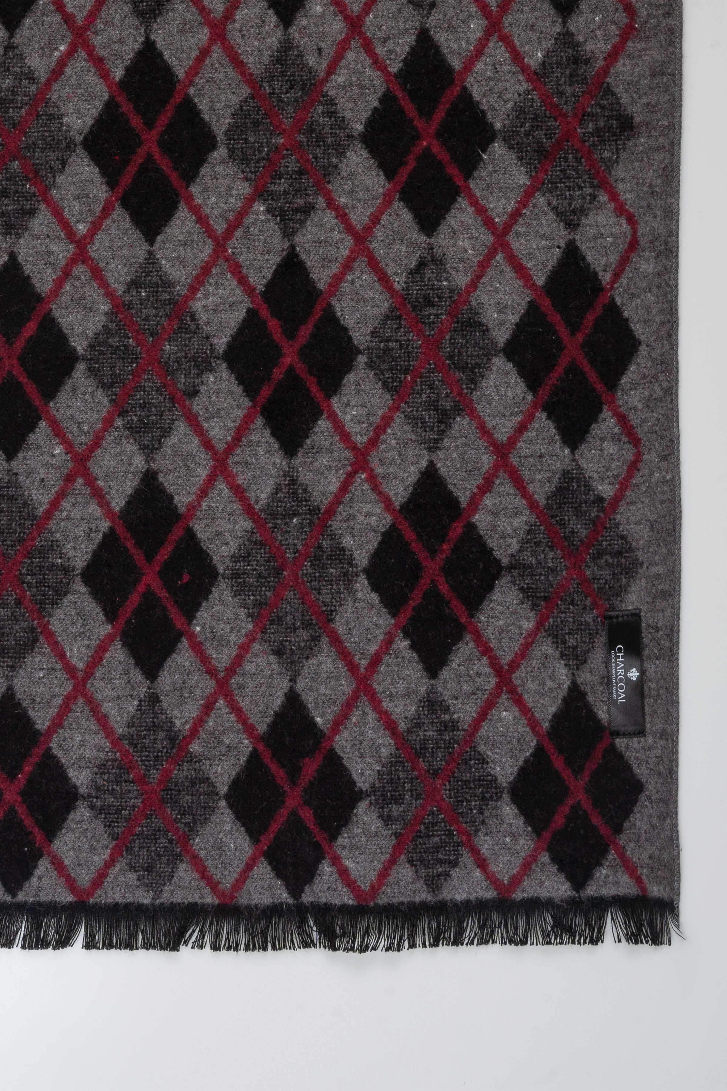 Scarf fabric close-up, gray knit with maroon-red and black diamond checks