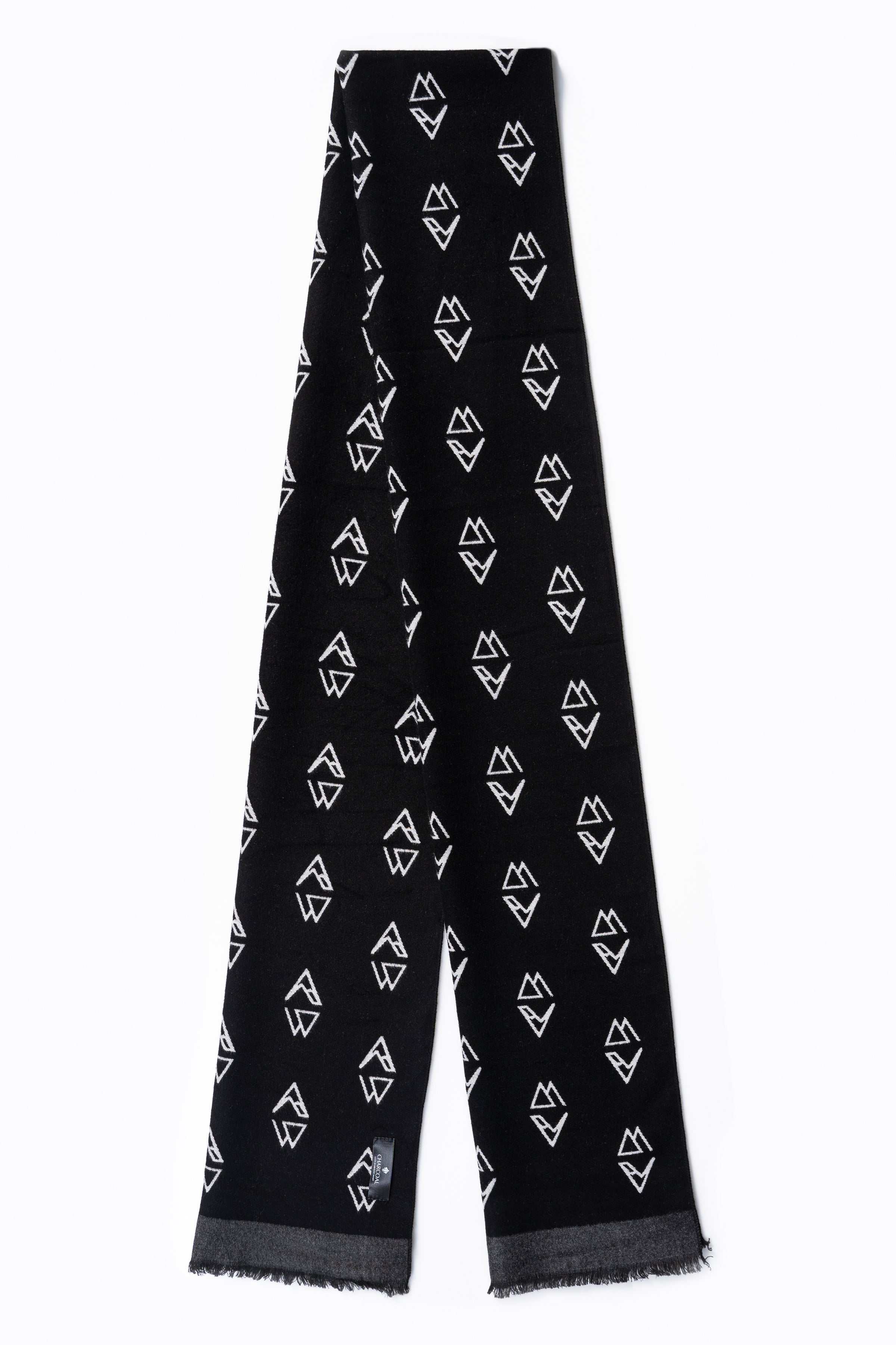 Black scarf with allover white geometric symbol pattern and fringed ends