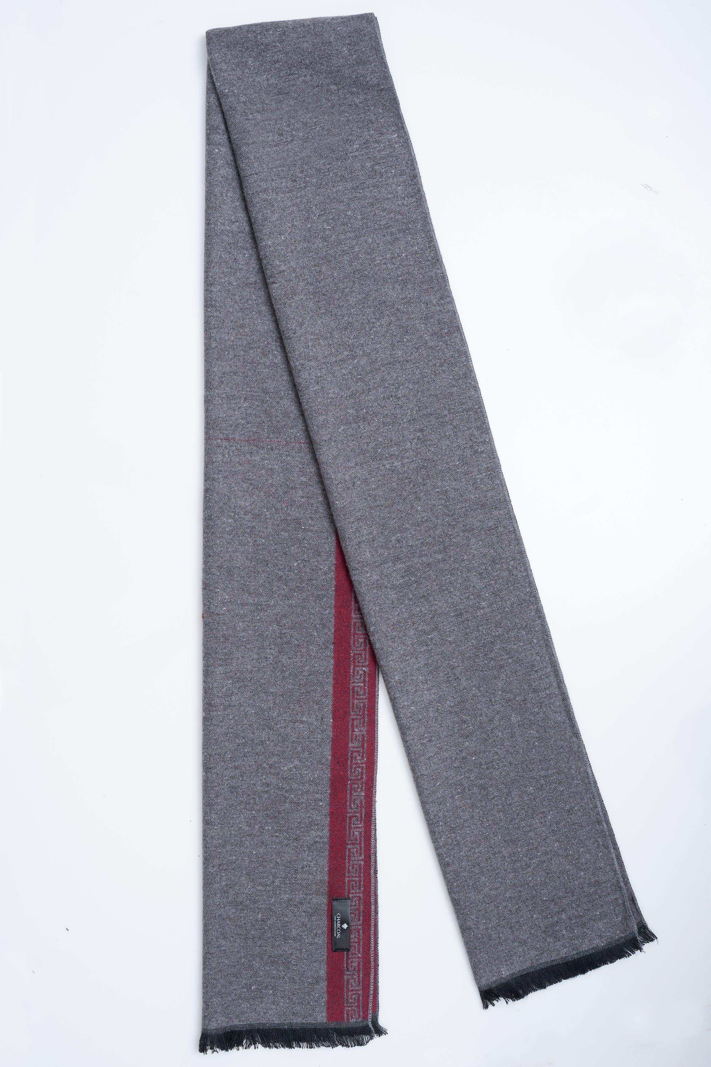 Gray scarf with red border panels and black fringe ends, folded