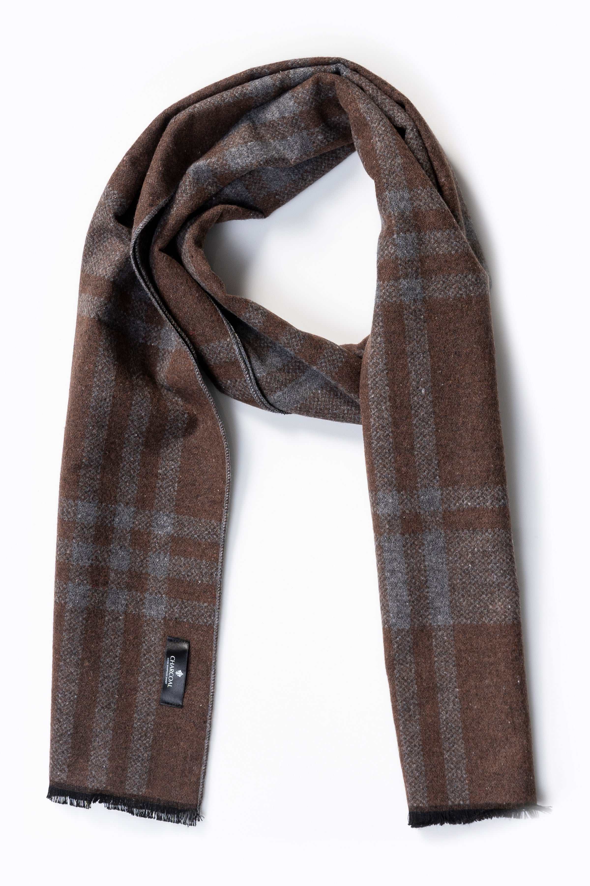 Brown plaid scarf with stitched tag, draped with fringe ends.