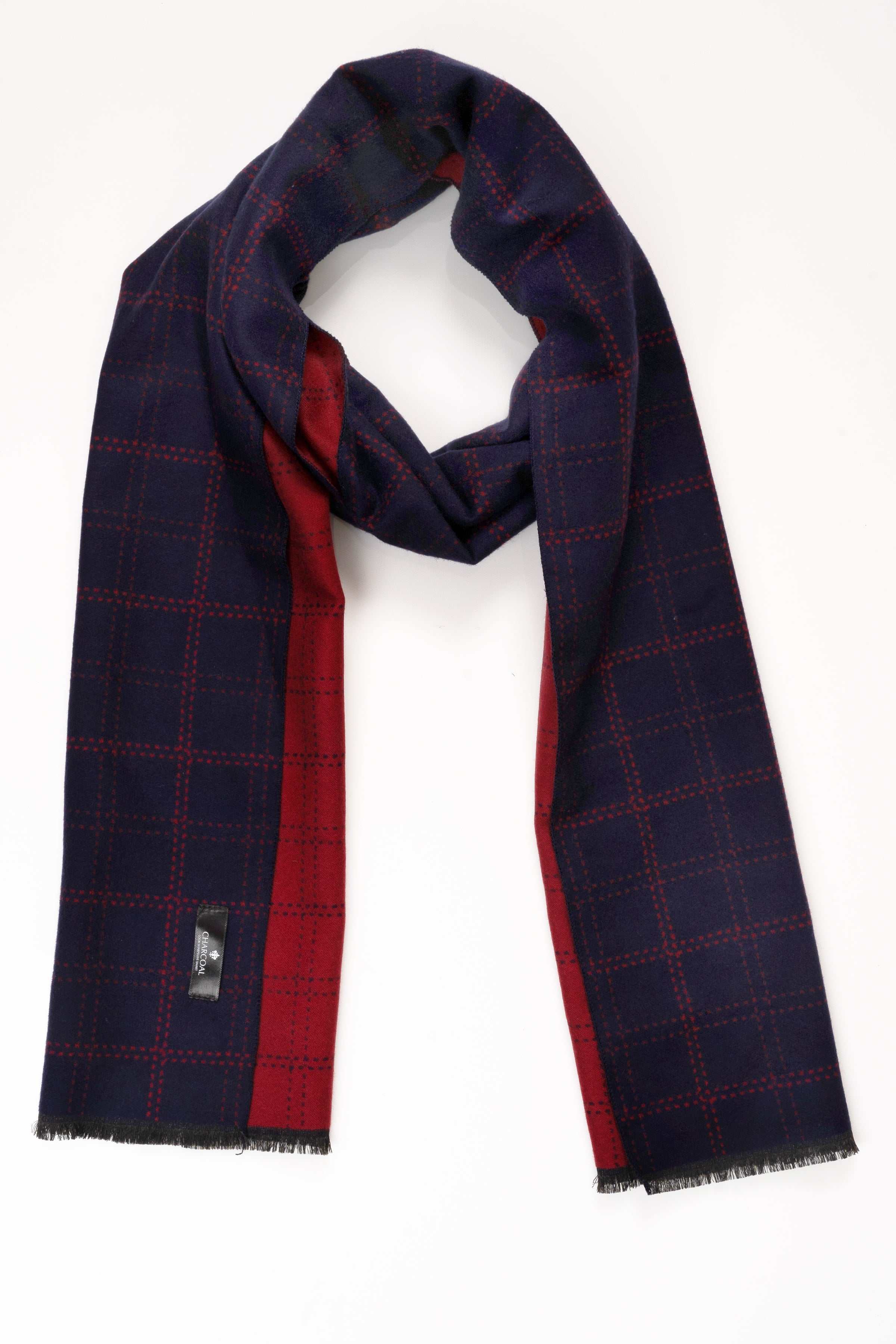 Draped plaid scarf in dark navy with red grid, frayed ends
