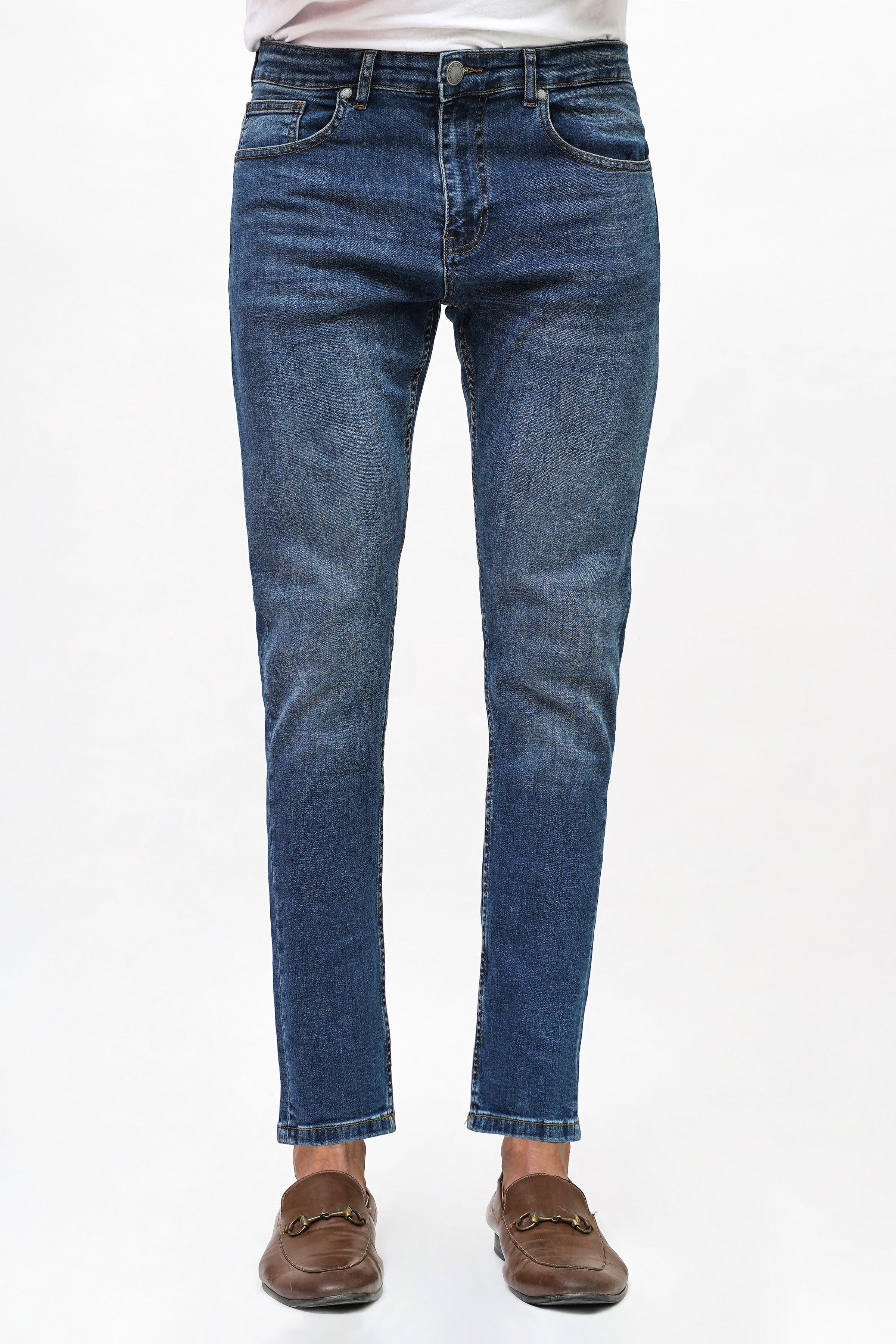 Mid blue skinny-fit denim jeans, button fly, belt loops, slim tapered legs.