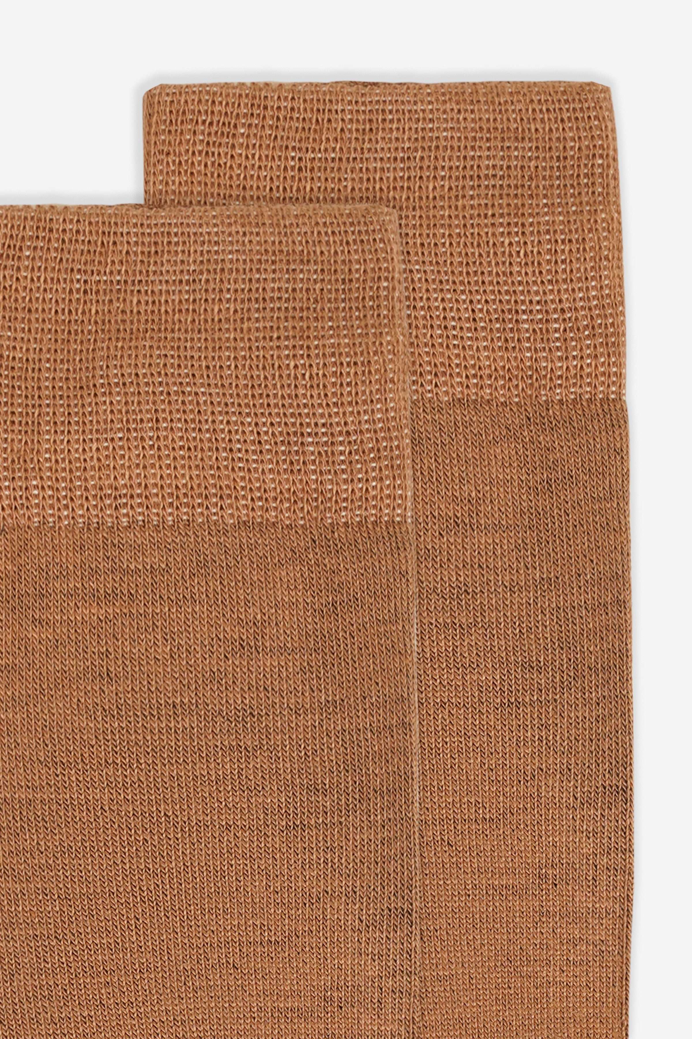 Wool socks fabric close-up, brown woven texture and stitched cuff edge